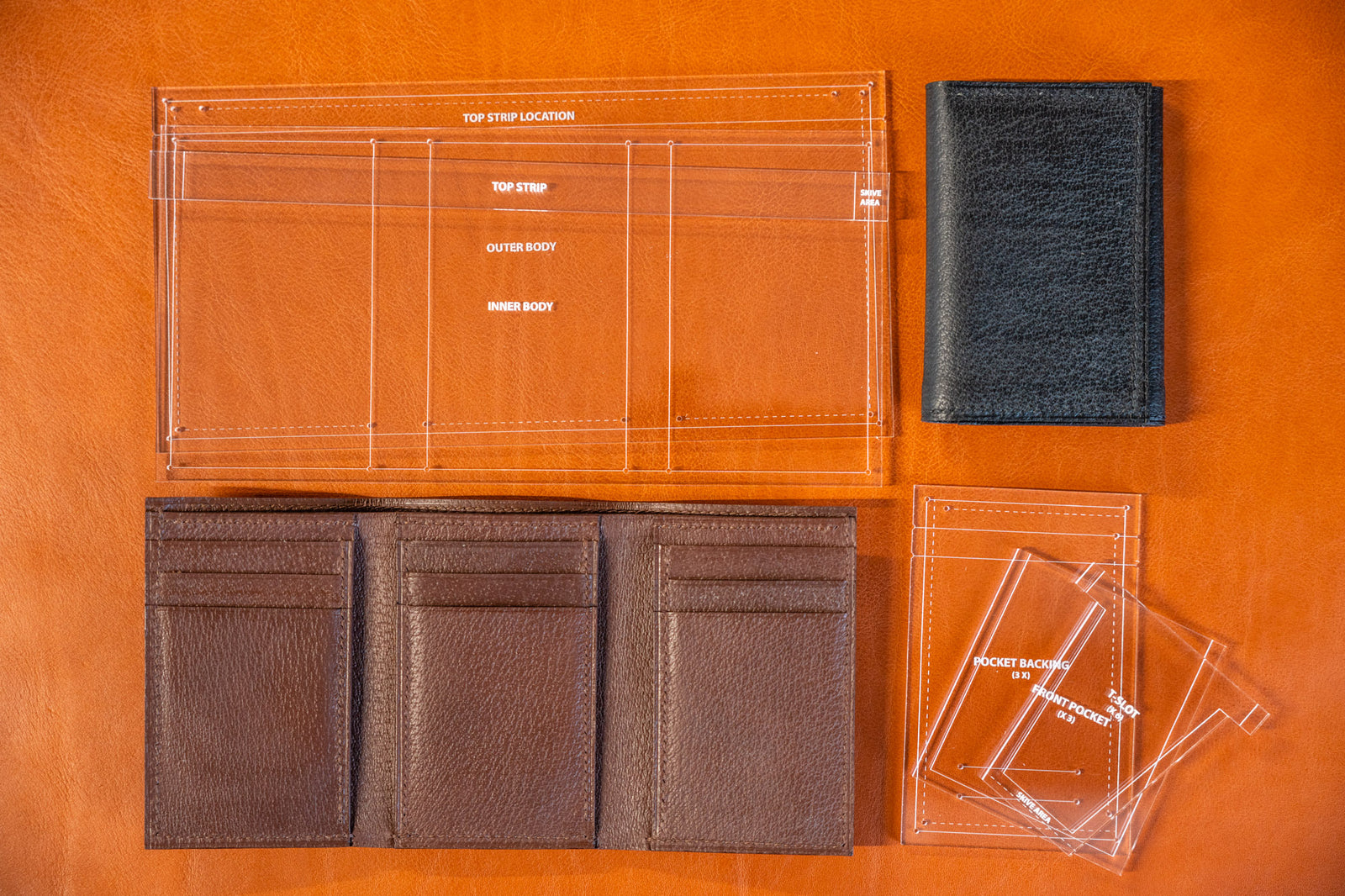 J.H.Leather trifold wallet acrylic template kit, surrounded by completed wallets